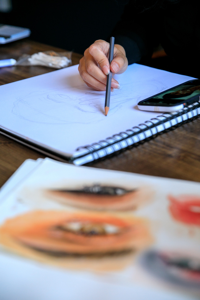 Close-up View of Artist Drawing in Sketchbook
